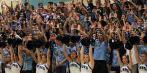 Students holding up Us with their hands.