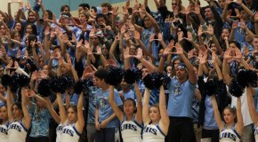 Students holding up Us with their hands.