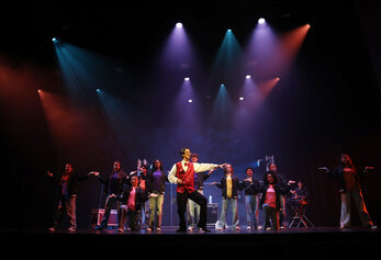 Students perform a group number from University High School’s Dreamland, with a student in a red bowtie leading center stage.